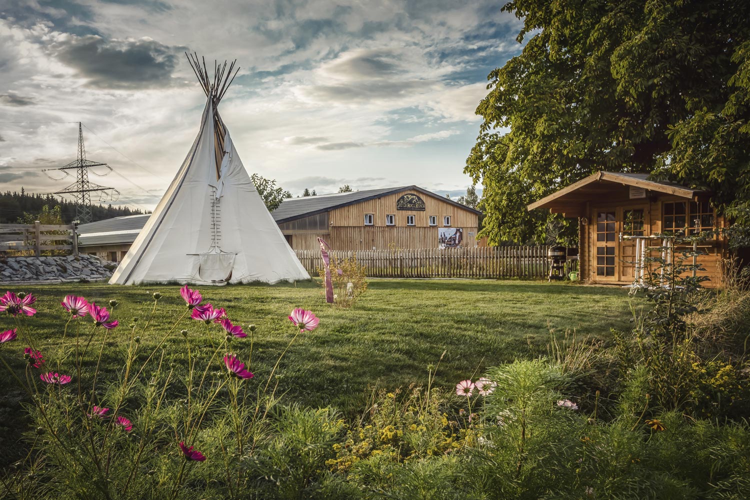 Silver Rock Ranch grounds with a tipi and flower meadow