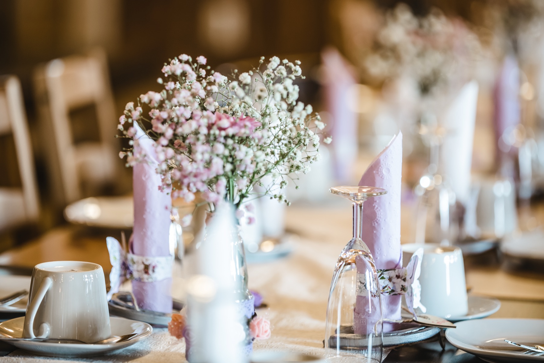 Hochzeitstafel mit Schleierkraut, Kerzen und rosa Servietten