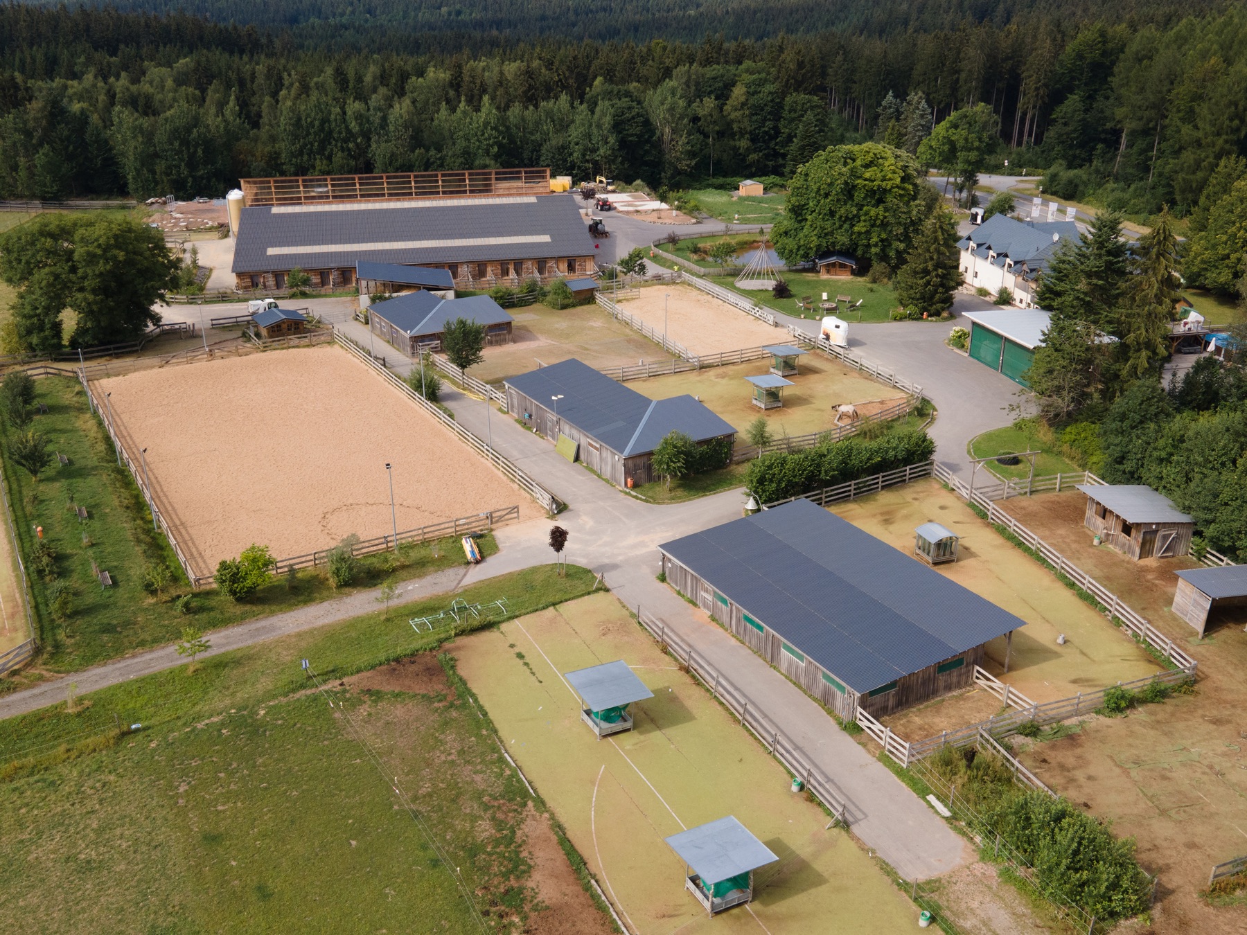 Luftbild der Silver Rock Ranch: Reithalle, Reitplätze, Paddocks und Weiden im Erzgebirge